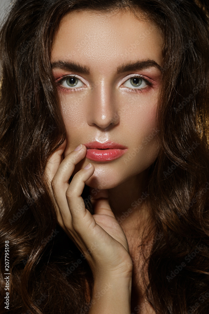 Fototapeta premium Portrait of sexy woman with a beautiful curly hair