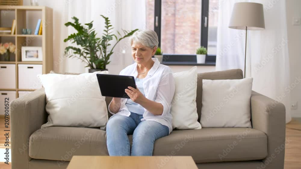 technology, age and people concept - happy senior woman with tablet pc computer at home technology, age and people concept - happy senior woman with tablet pc computer at home