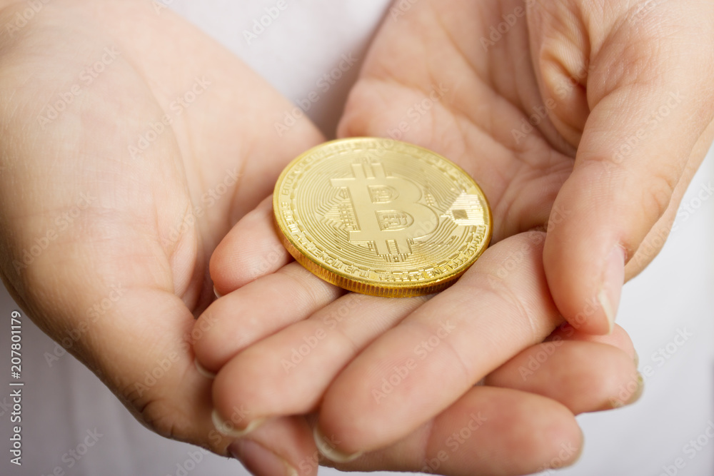 female hands closeup with the coin bitcoin female hands closeup with the coin bitcoin