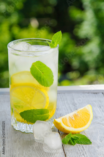 Citrus lemonade in garden setting,summer drink.