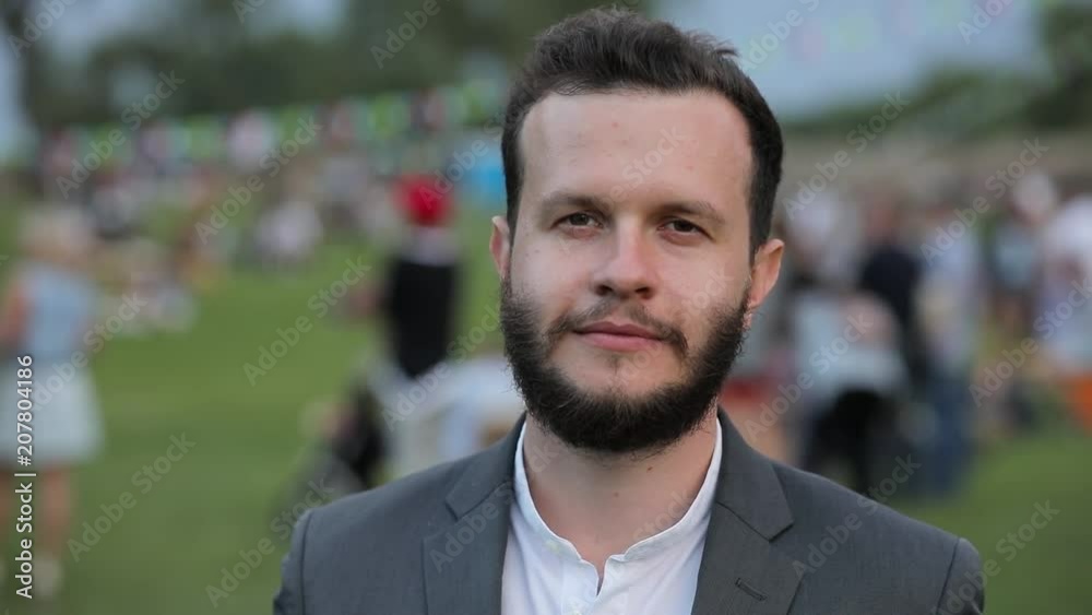 Face of happy smiling caucasian man outdoor, people on background Face of happy smiling caucasian man outdoor, people on background