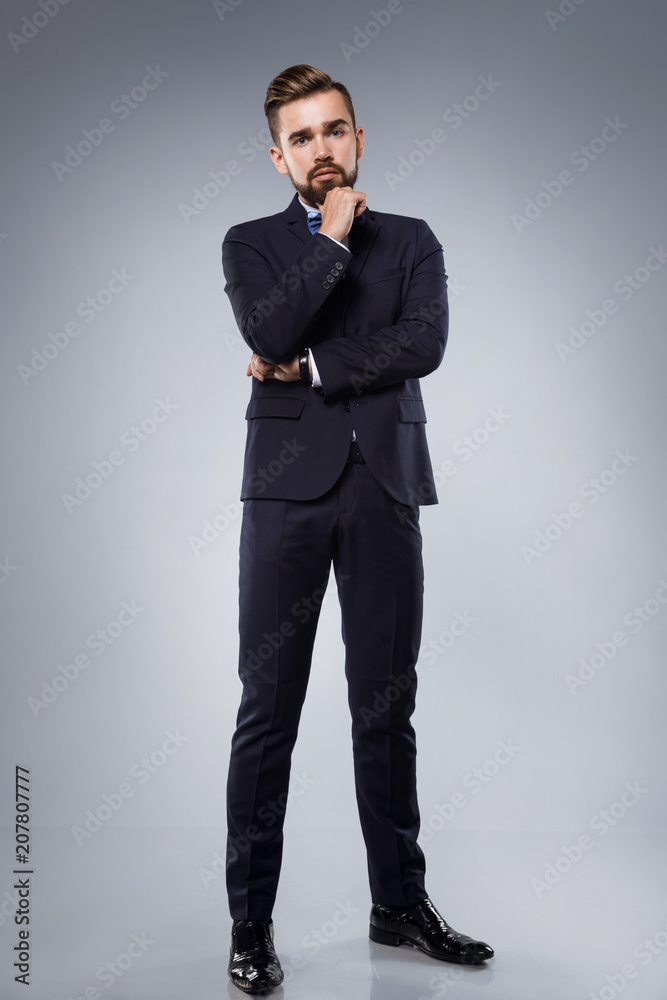 Stylish handsome man wearing a classic suit with bow-tie Stylish handsome man wearing a classic suit with bow-tie
