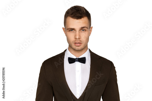 Man in tuxedo and vest in white shirt on white background