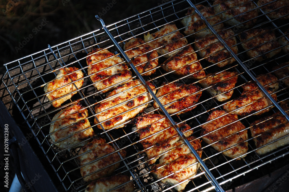 Chicken meat is grilled on the nature.
Chicken meat is grilled on the nature.