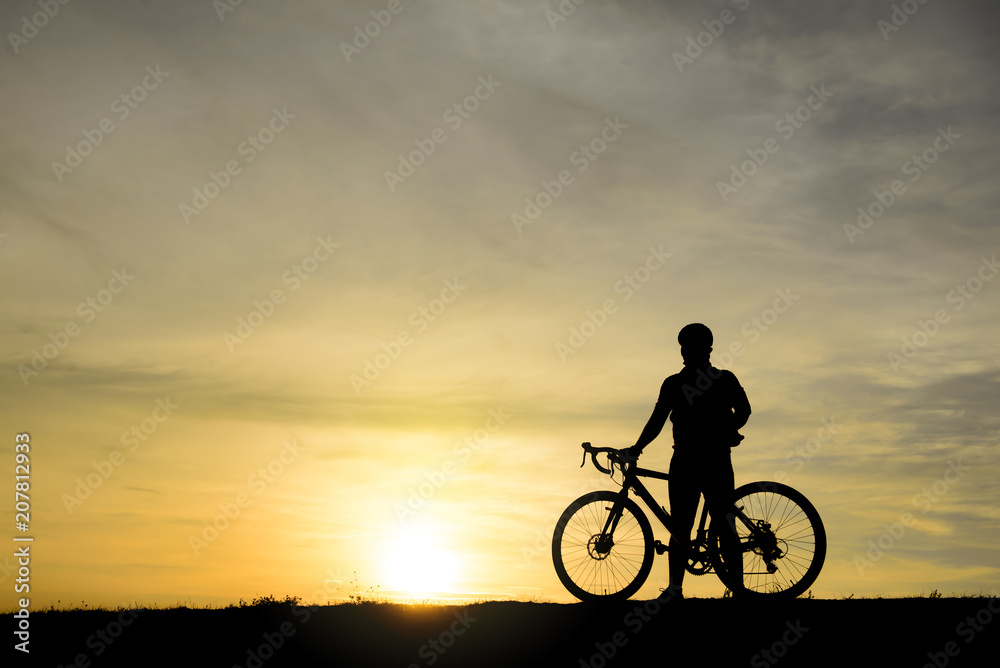 Silhouette of handsome man lift up bicycle on your head on sunset,sport man concept Silhouette of handsome man lift up bicycle on your head on sunset,sport man concept