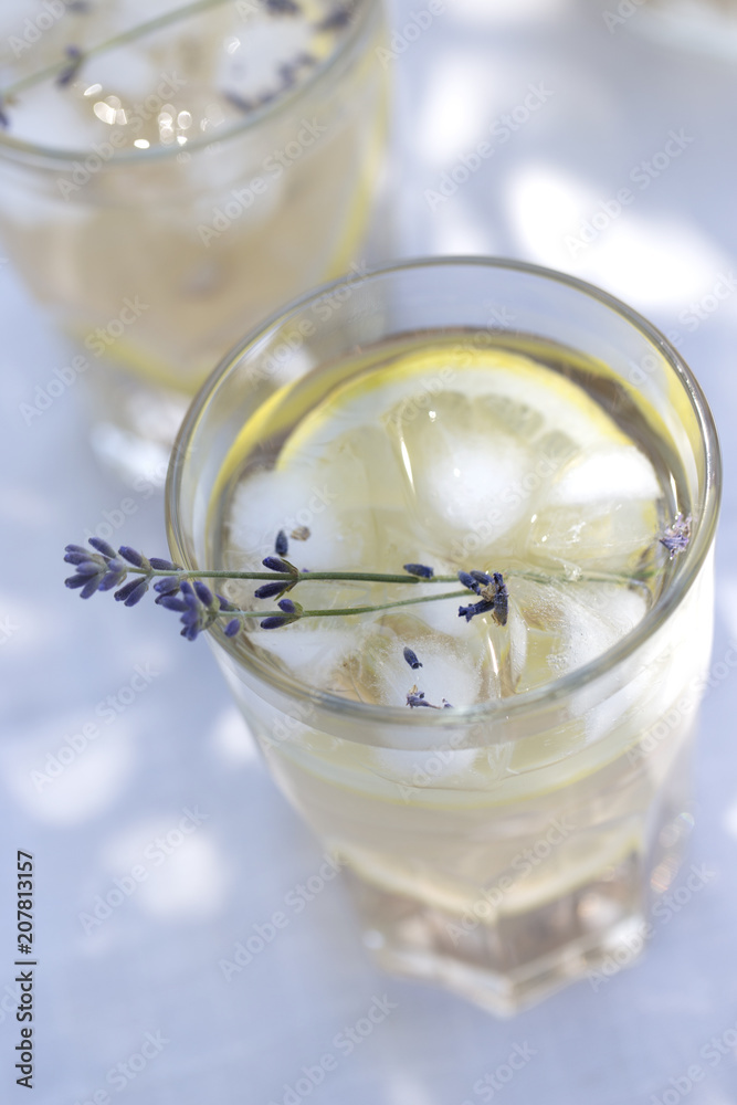 Lavender lemonade in cocktail glasses. Lemonade with lemons and lavender Lavender lemonade in cocktail glasses. Lemonade with lemons and lavender