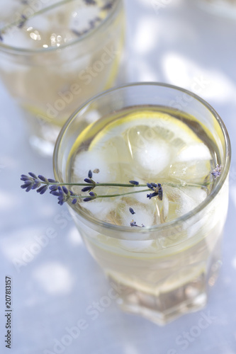Lavender lemonade in cocktail glasses. Lemonade with lemons and lavender