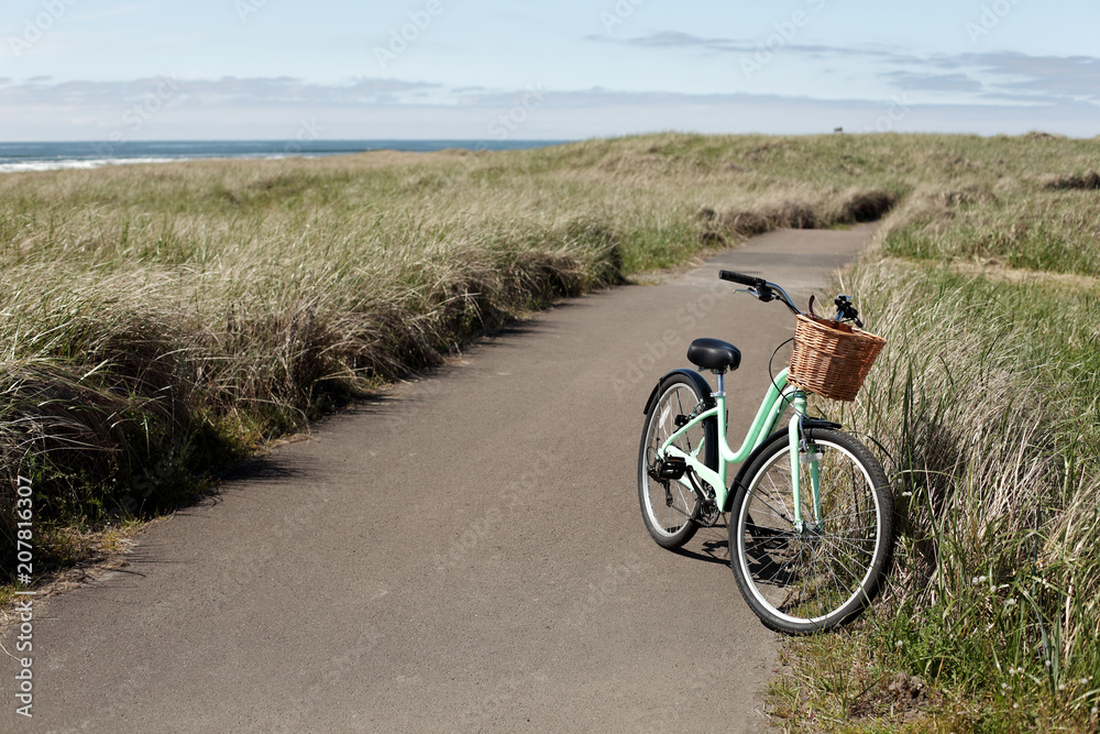 Fototapeta premium Women's bicycle on a bike path at Long Beach, WA.