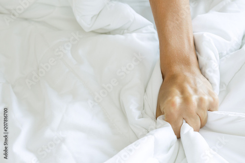 Tableau sur toile Hand squeezing bed sheet