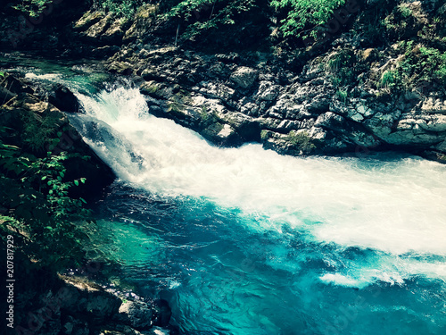 blue transparent mountain stream among rocks