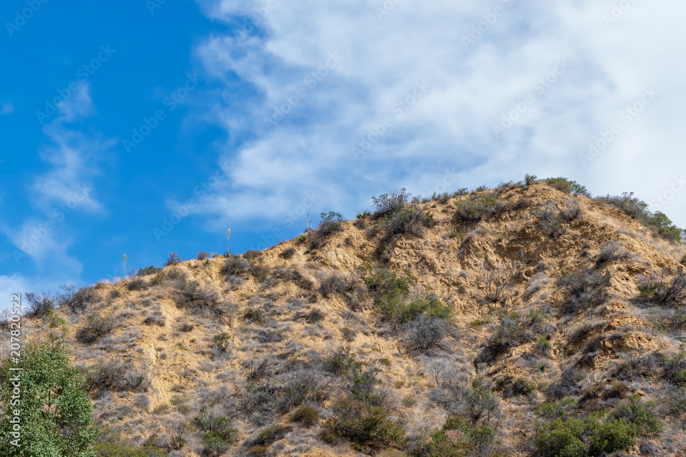 Climbing mountain ridge line on hot summer morning in California mountains