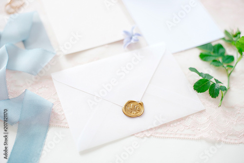 wedding invitation card as a decorated letter with flowers and ribbons top view