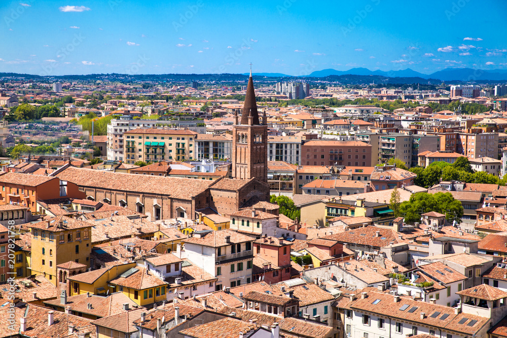 Panoramic cityscape of Verona, Veneto, Italy. Orange tiling  medieval roofs. Bright sunny summer day with blue sky.