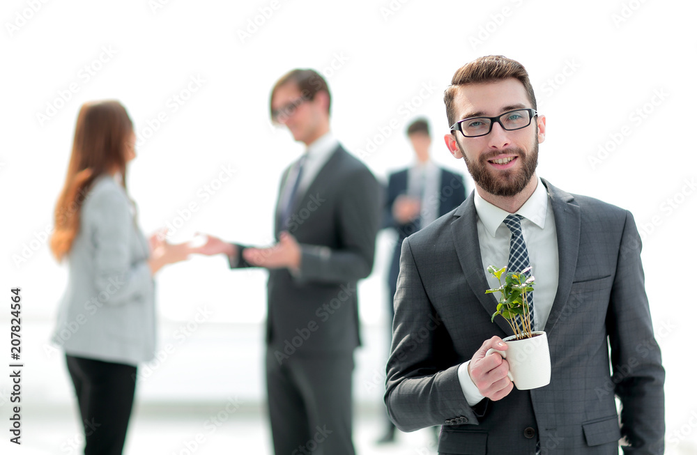 businessman with green young escape on blurred background businessman with green young escape on blurred background
