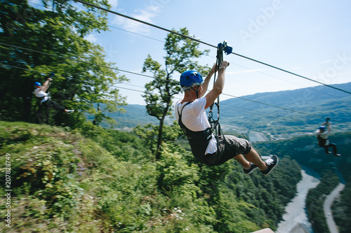 zip line on the sky high in the mountains over a beautiful forest.