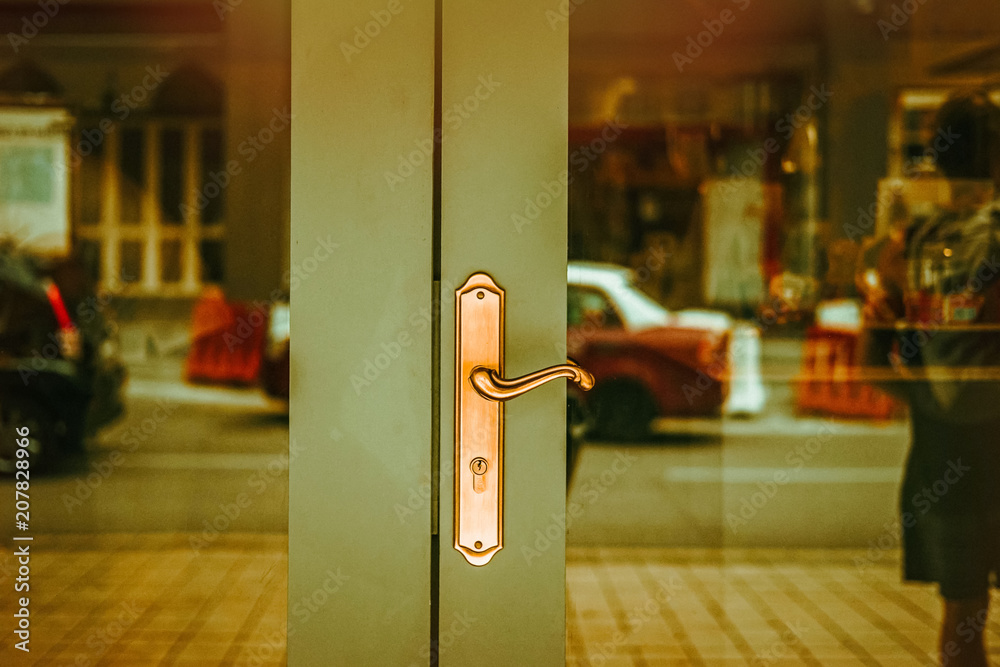 Green double doors with golden handle. Modern classic exterior design. Vintage tone filter effect Green double doors with golden handle. Modern classic exterior design. Vintage tone filter effect