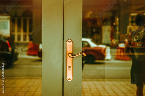 Green double doors with golden handle. Modern classic exterior design. Vintage tone filter effect