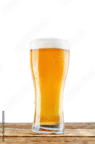 Glass of cold light beer on a wood table