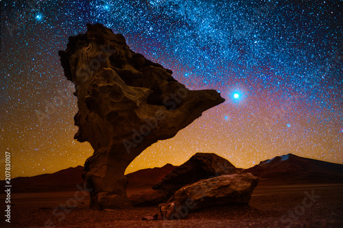 Rock formation named Arbol de Piedra in the desert with starry sky on the background. Bolivia