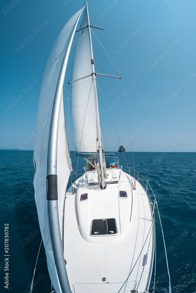 Fototapeta premium Sailing boat moves in a sea, view from the bow