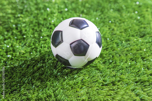 Football ball on green football field