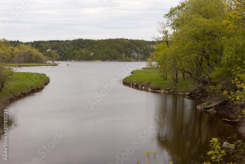 Inlet with Grassy Lawns on a Cloudy Day