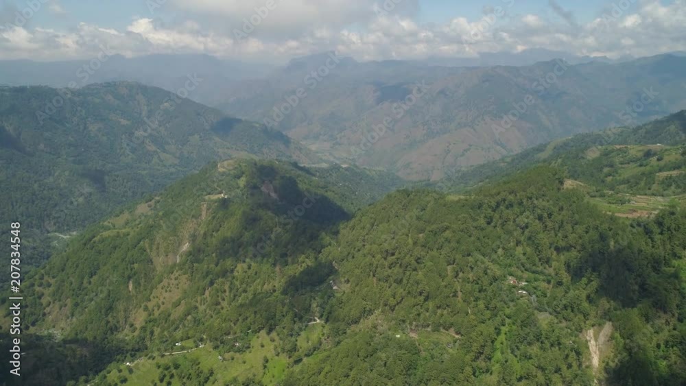 Aerial view of mountains covered forest, trees. Cordillera region. Luzon, Philippines. Slopes of mountains with evergreen vegetation. Mountainous tropical landscape. Aerial view of mountains covered forest, trees. Cordillera region. Luzon, Philippines. Slopes of mountains with evergreen vegetation. Mountainous tropical landscape.