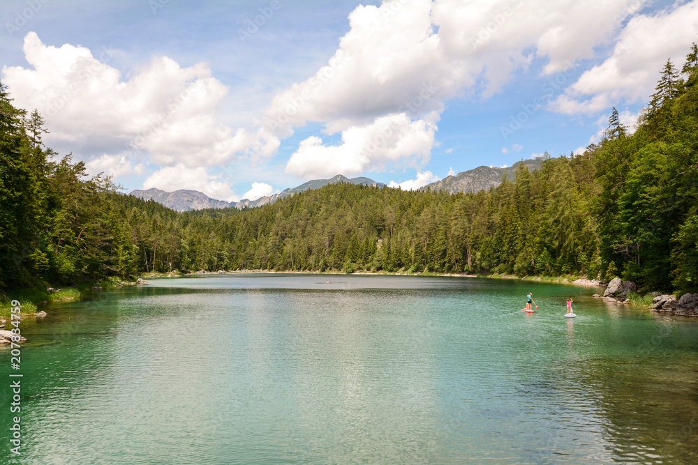 Stand up paddling at lake Eibsee in the bavarian alps near Garmisch Partenkirchen, Bavaria Germany