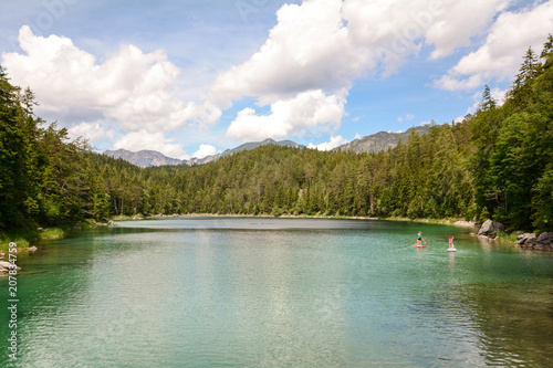 Stand up paddling at lake Eibsee in the bavarian alps near Garmisch Partenkirchen, Bavaria Germany
