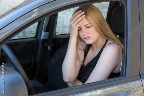 woman being sick in a car 