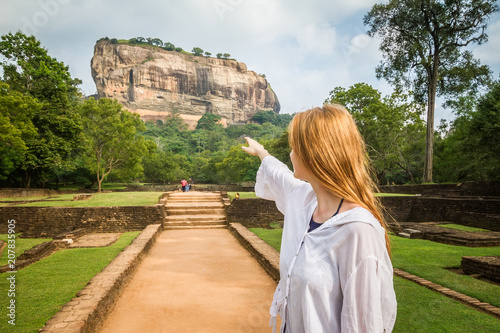Sigiriya, Sri Lanka. A girl stands in the background of the famous mountain