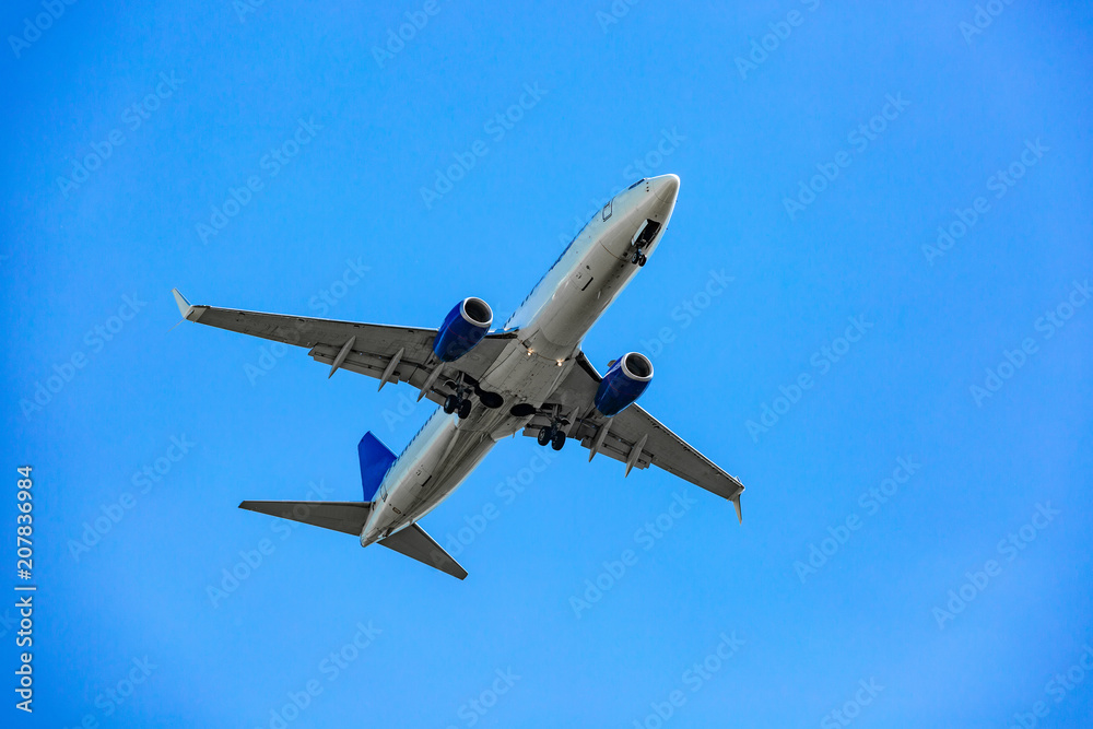 Large passenger plane flying in the blue sky Large passenger plane flying in the blue sky