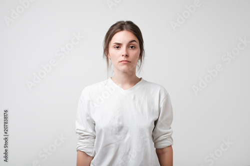Portrait of caucasian woman with serious facial emotion like she is asking what do you mean, really 