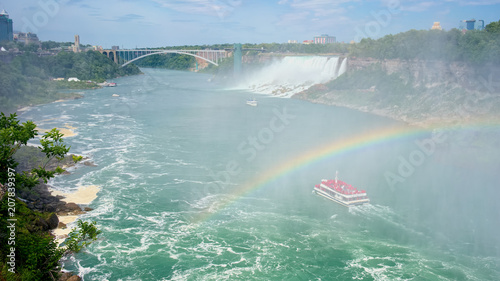 Rainbow over boat on Niagara River, Niagara Falls, on the border of Canada (Ontario) and United States (New York).