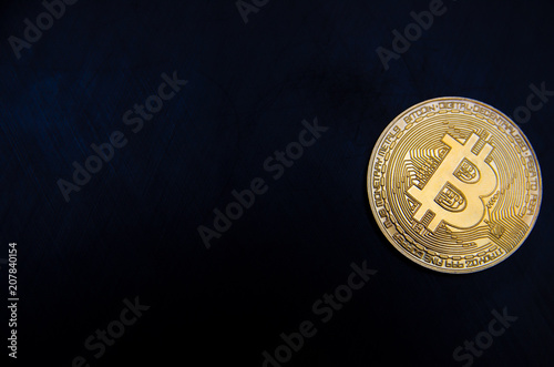 golden bitcoin on a black background with a place for an inscription