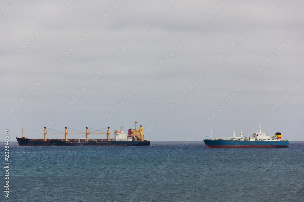 Cargo ships heading to pier in Las Palmas, Spain. Intercontinental maritime transportation, logistics concept
