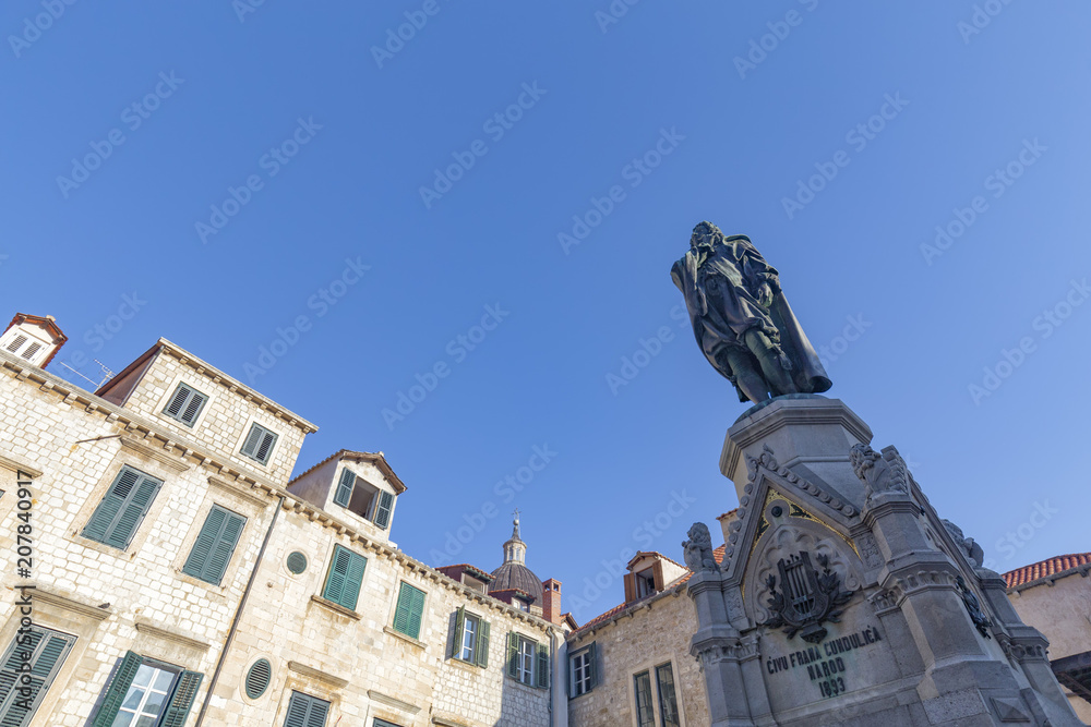 A statue and old stone buildings in the old city of Dubrovnik, Croatia.