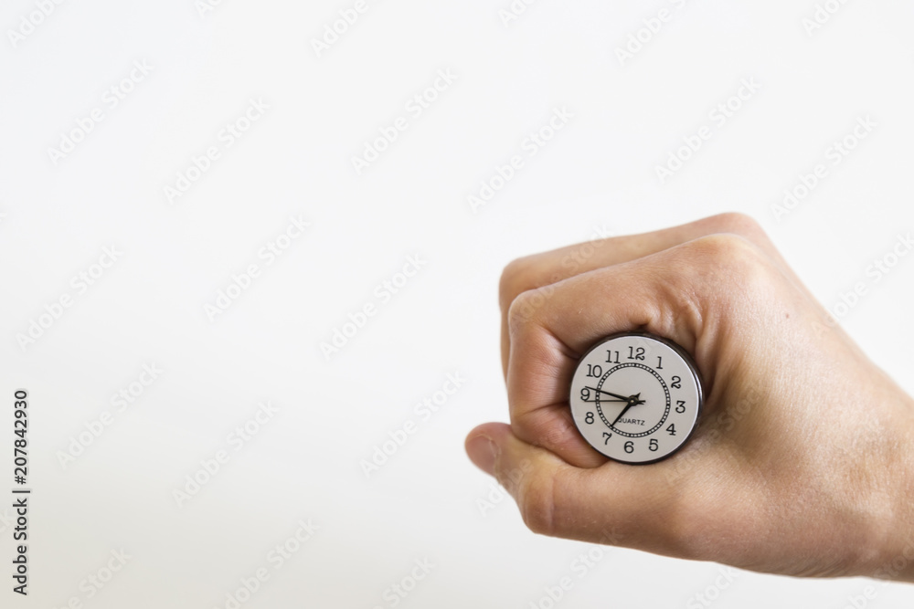 clock with the hand on the white background. time to investment, lesson, reading book and exam. clock with the hand on the white background. time to investment, lesson, reading book and exam.