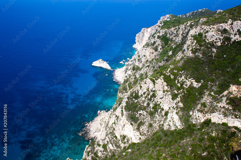 Rocky mountain coast bay aerial view. Beautiful landscape. Blue clear ocean sea water next to cliff in Corfu Greece. Travel and adventure time. Vacations. Traveling abroad