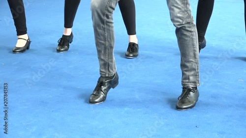 Legs of tap dancers moving and tapping live performance at theatre. Close up of dancing feet, shiny light on blue carpet, 50s music. Vintage dance style, art, sport and musical culture