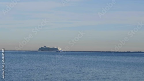 Cruise ship floating away on the waves of the sea. photo