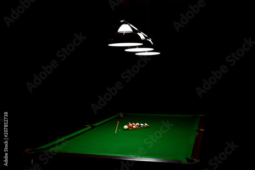 Game of billiards on a table with green cloth  photo