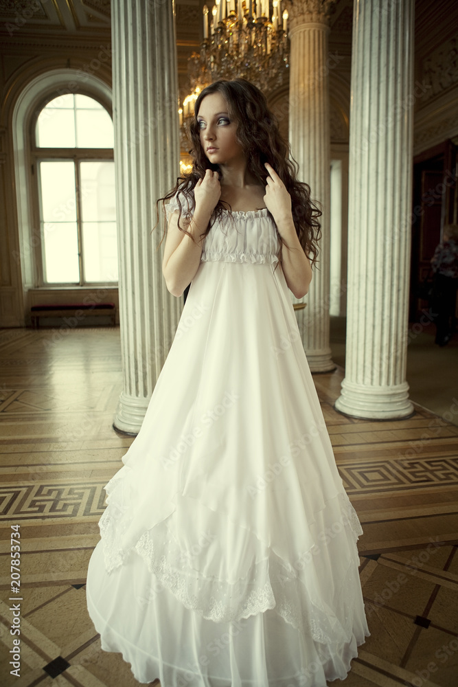 Obraz premium Portrait of a beautiful young victorian lady in white dress