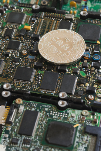 Bitcoin Mining Concept. Silver bitcoins on electronic circuit board.