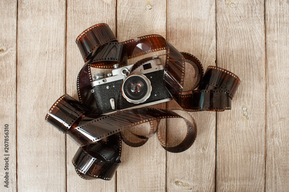 retro camera surrounded by photographic film