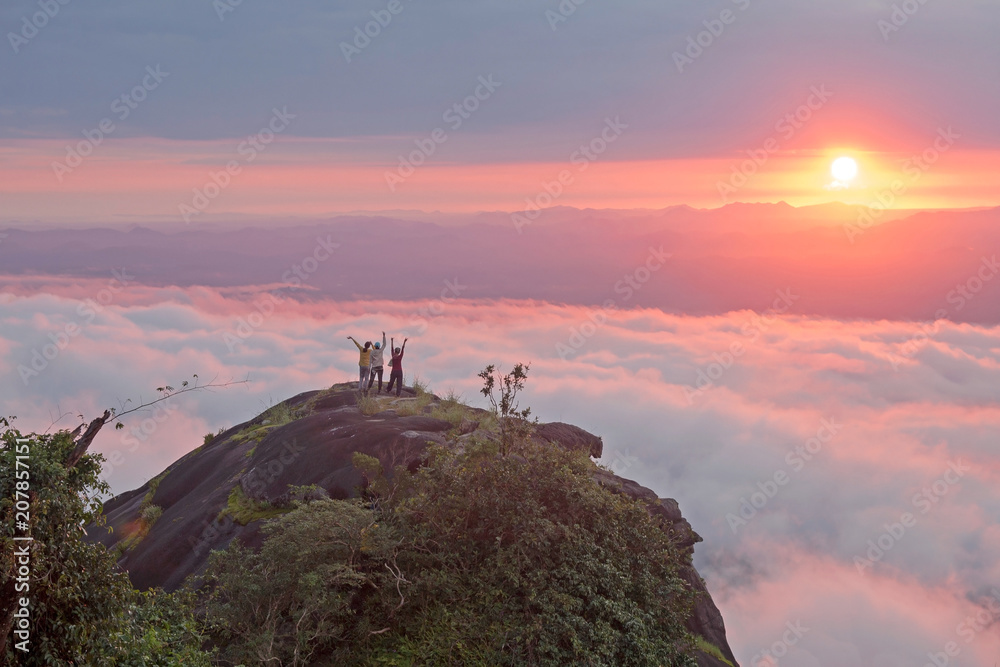 the tourist Watch the sunrise on the mountain in a beautiful thailand park.