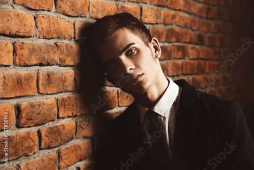 leaning against brick wall