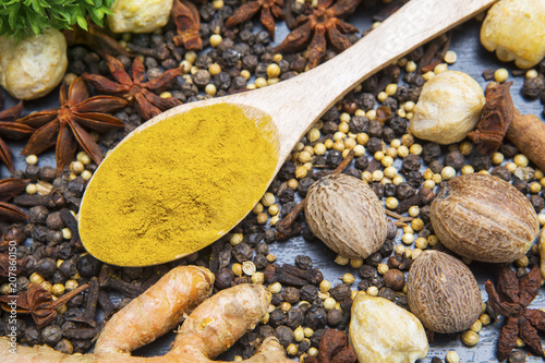 Fresh turmeric powder with various spices © Creativa Images