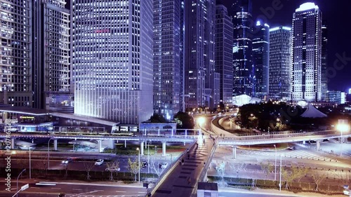 bird's-eye view of Big City traffic & skyscraper at night,fast moving people silhouette on flyover,shanghai landmark building,huanqiu-building,shimao.use Ultra-wide-angle lens shoot.	 photo