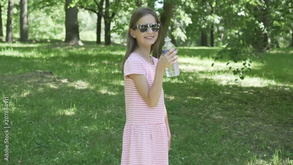 Girl drinking water out of a plastic bottle HD Girl drinking water out of a plastic bottle HD